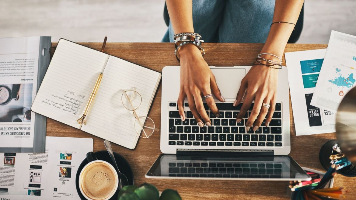 businesswoman using a laptop while working remotely | free websites to make money online