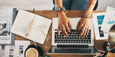 businesswoman using a laptop while working remotely | free websites to make money online