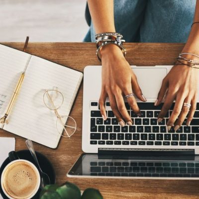 businesswoman using a laptop while working remotely | free websites to make money online